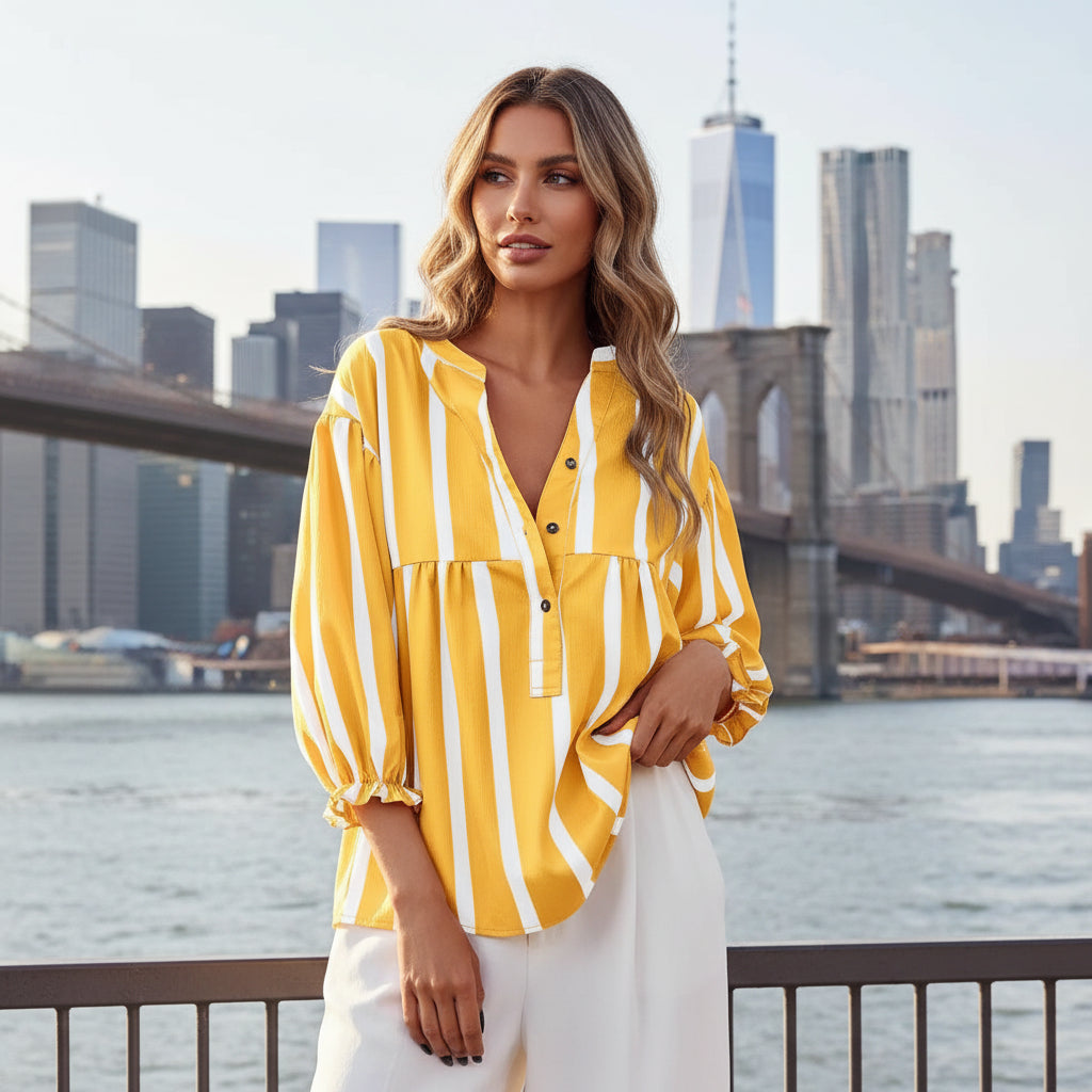 Woman wearing a yellow and white striped blouse with a blurred background